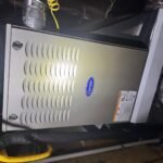 HVAC technician diagnosing air conditioner problems in a Houston home during summer